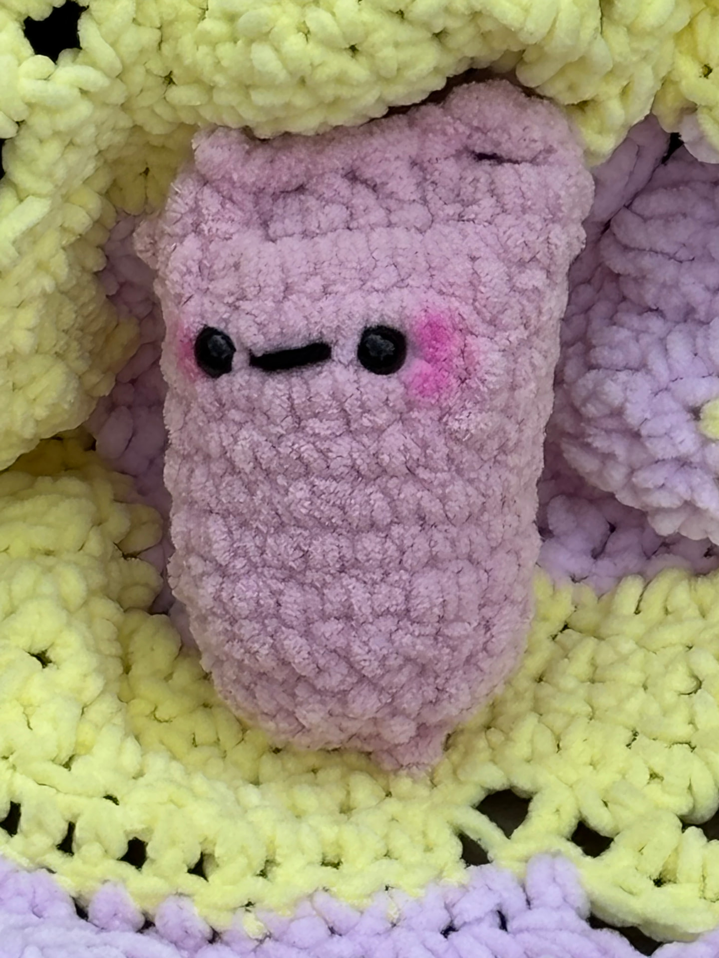 Pink chunky crochet pocket plush with bright blushed cheeks